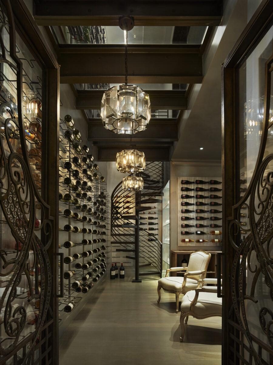 A wine gallery behind an ornate iron gate, racking on both walls, built by Fine Line.